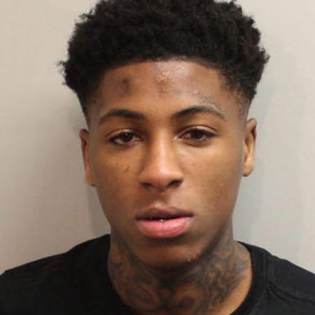 YoungBoy appears in a mugshot, wearing a black t-shirt
